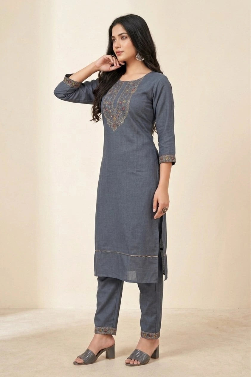 Woman wearing a gray kurta with embroidery on a beige background
