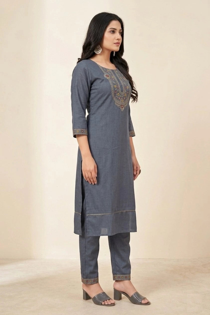 Woman wearing a gray kurta with embroidery on a beige background