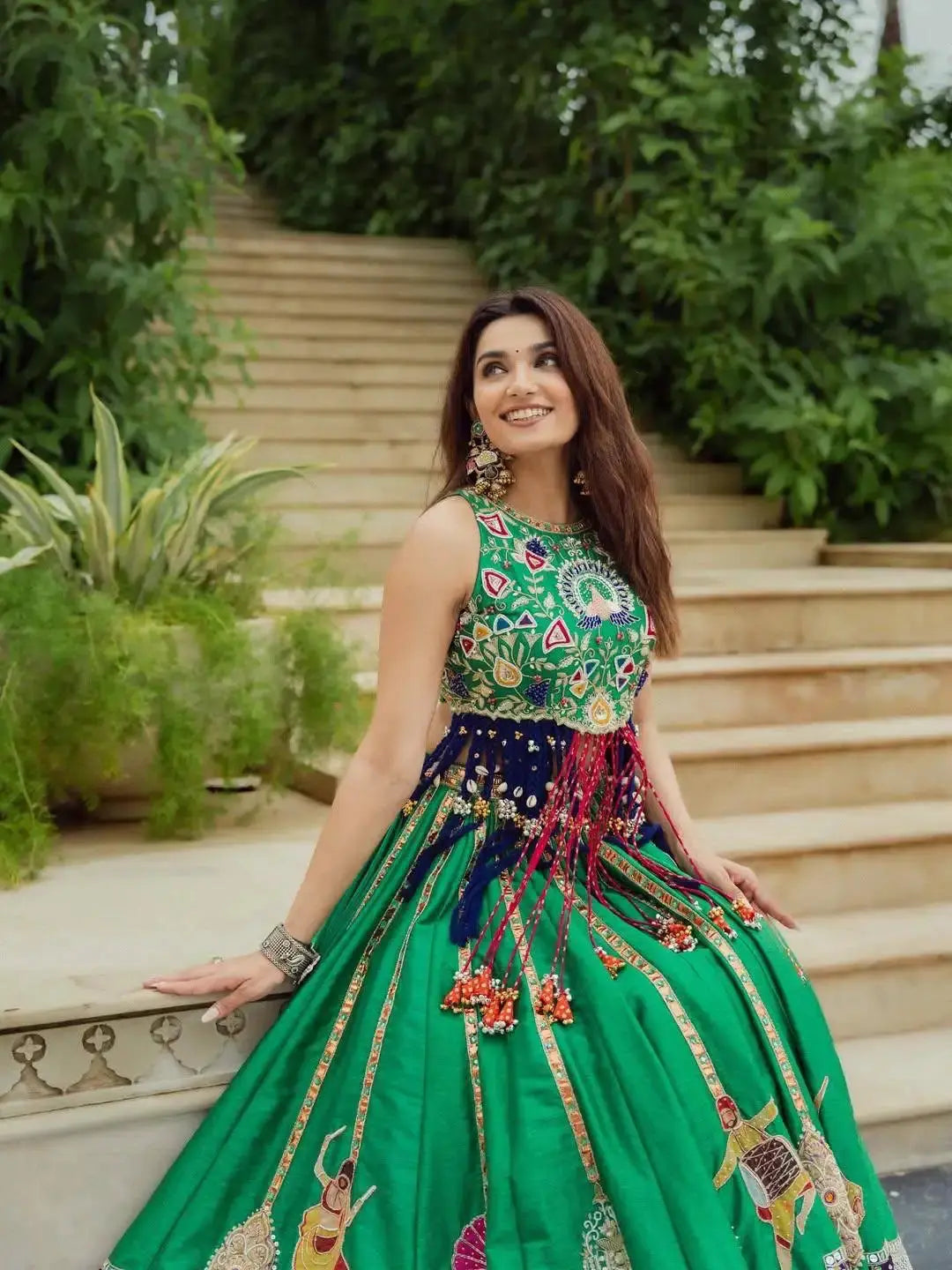 Green Digital Print Lehenga seated view with earrings and styling detail