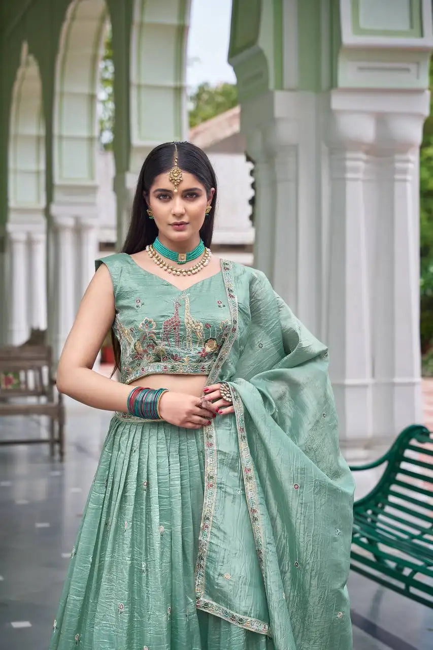 Close-up of green gold crush choli with multicolor giraffe and floral thread embroidery