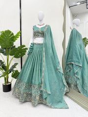 Full mannequin view of green thread embroidered lehenga showing ruffle waist and wide Mughal animal border
