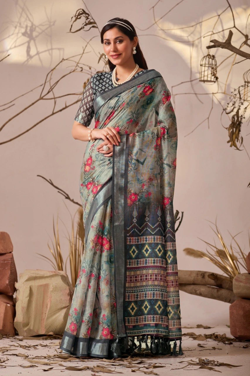 Woman wearing a floral saree with a patterned border against a natural background