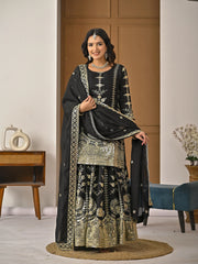 Woman in traditional black and gold embroidered outfit in a room setting