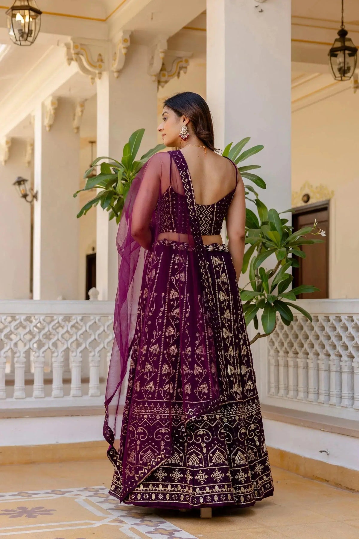 Wine Lehenga back view – open back choli with dori tie-up, gold thread floral work on skirt