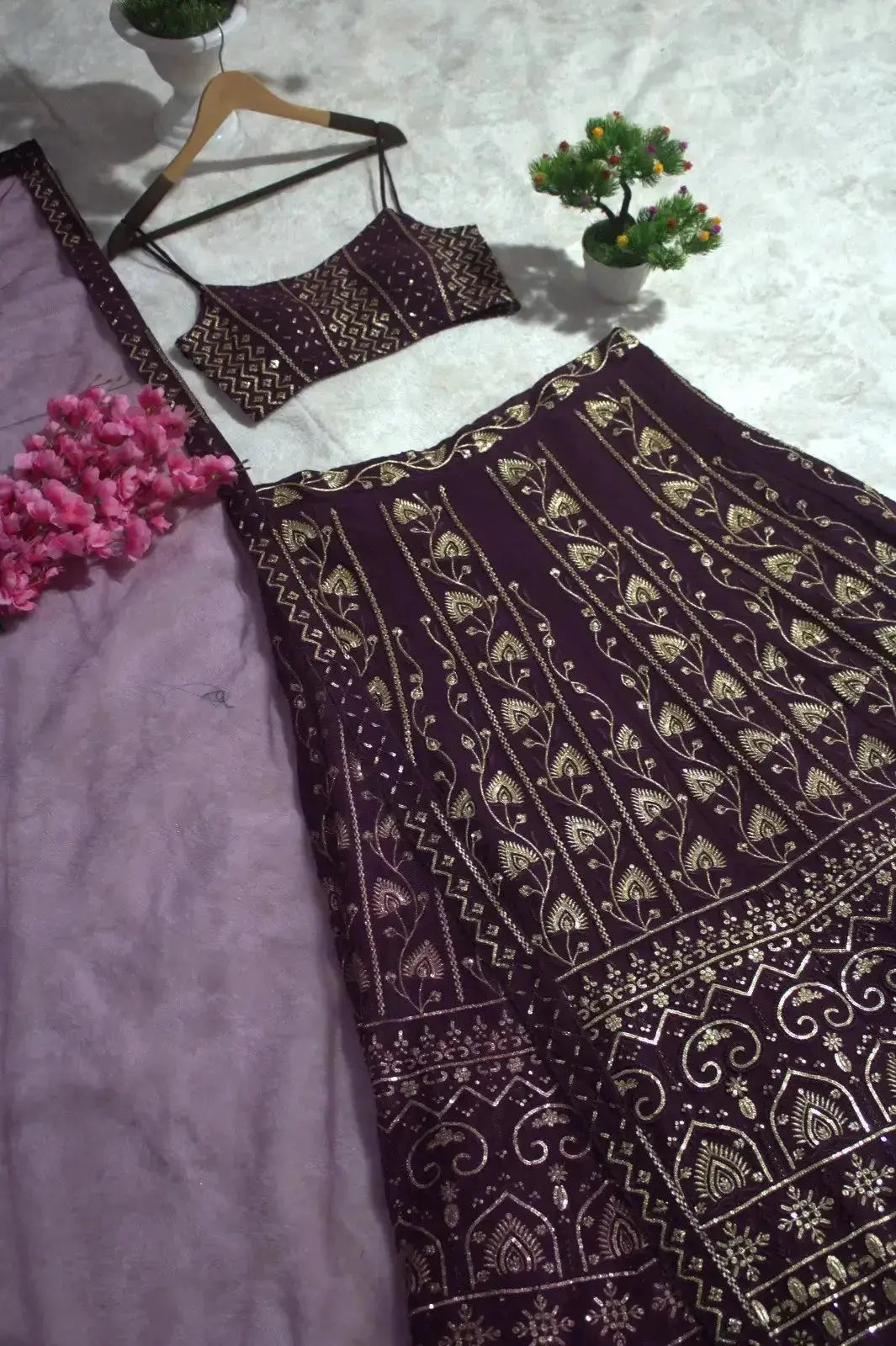 Wine Georgette Lehenga skirt detail flat lay – gold floral vine embroidery and heavy sequin border close-up