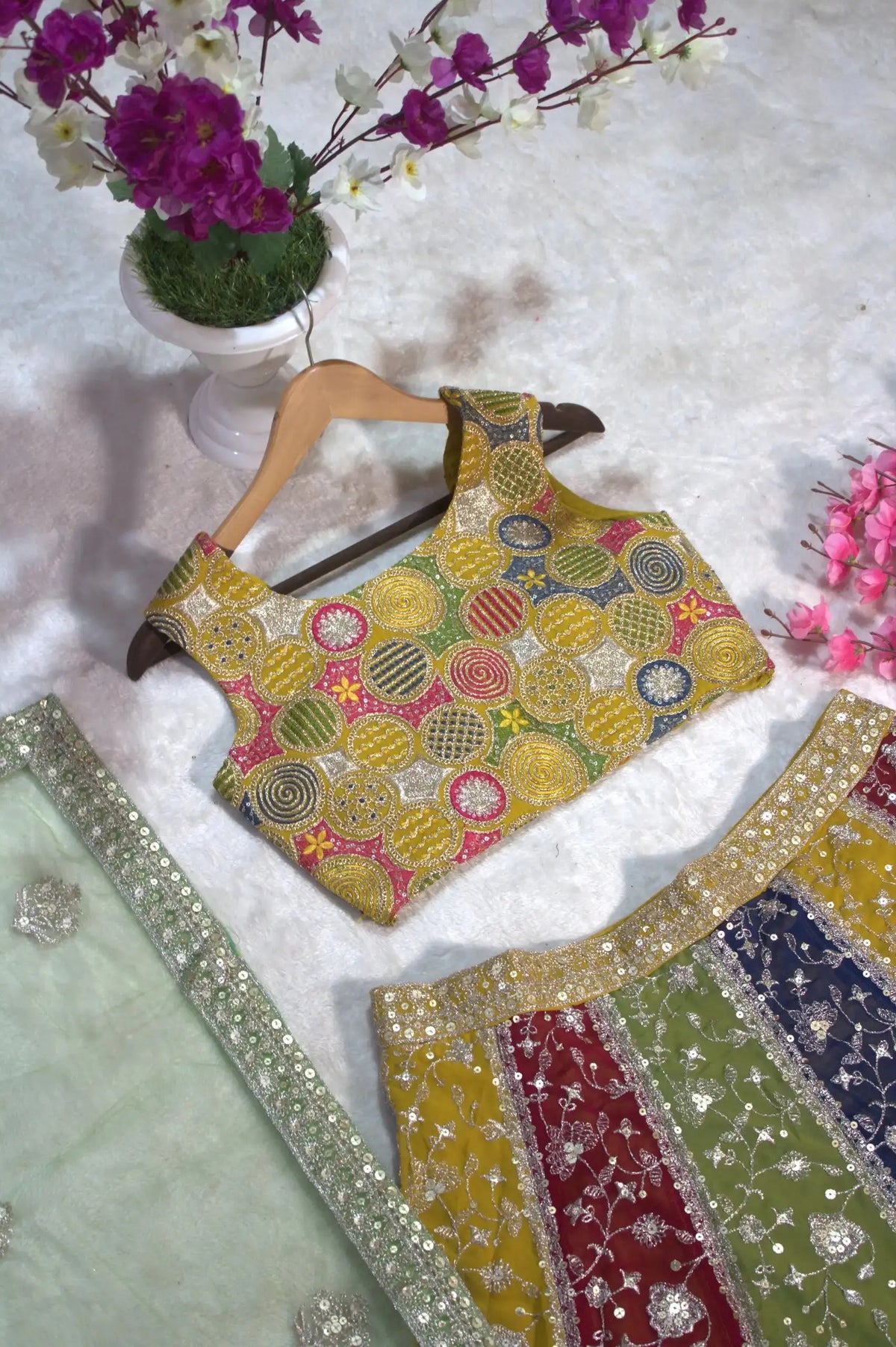 Multicolor embroidered choli back flat lay – covered back, multicolor circular embroidery detail