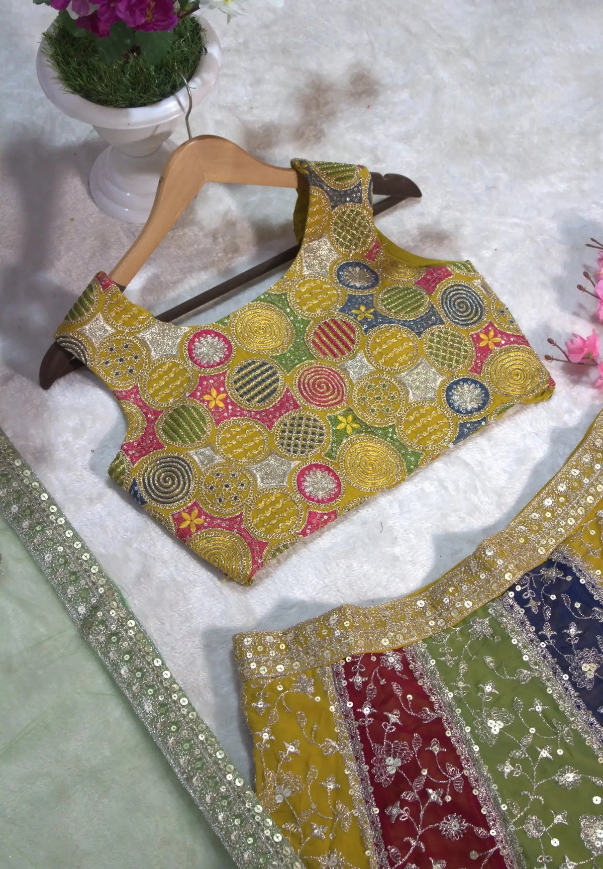 Multicolor embroidered choli flat lay on hanger – circular zardosi work in multicolor thread and sequins