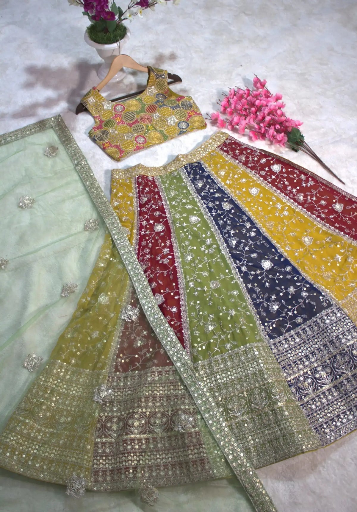 Multicolor Lehenga full flat lay spread – colorblock faux georgette panels with sequin embroidered border