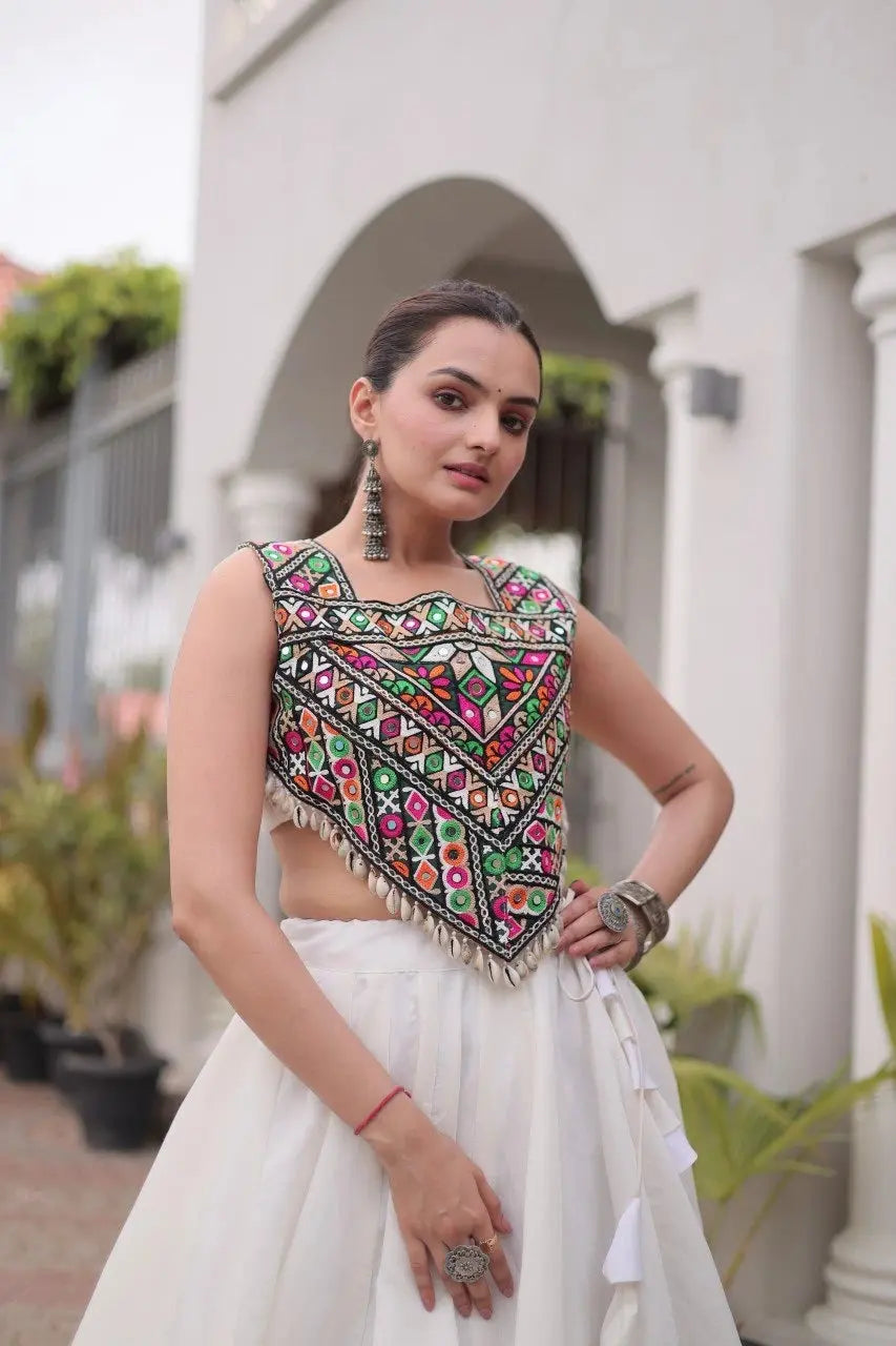 White Lehenga Gamthi choli close-up – multicolour geometric folk embroidery with gota, mirror and kodi shell fringe