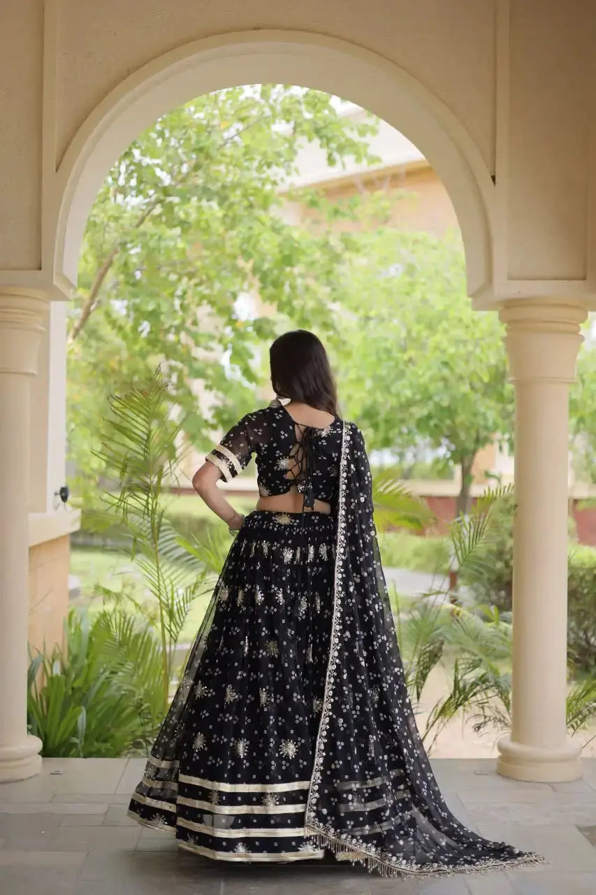Black Bandhej Print Lehenga back view – lace-up dori tie-up choli back, full circular skirt with gota lace hem and fringe dupatta