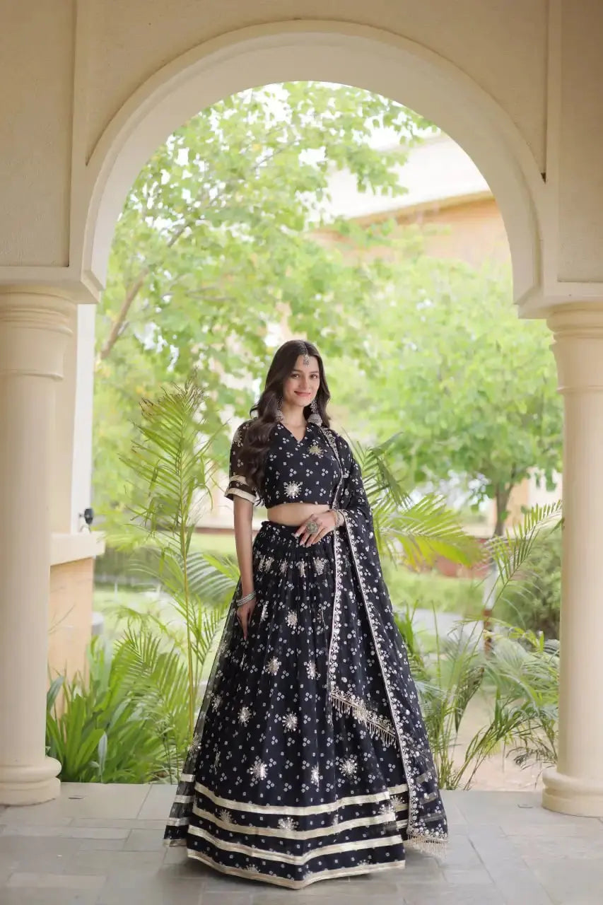 Black Bandhej Print Lehenga front view – Faux Georgette with sequin sunburst motifs, gold zari embroidery and gota lace border