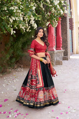 Black Floral Print Lehenga 3 quarter view – red patola dupatta with gold zari border and tassel fringe, sangeet party wear