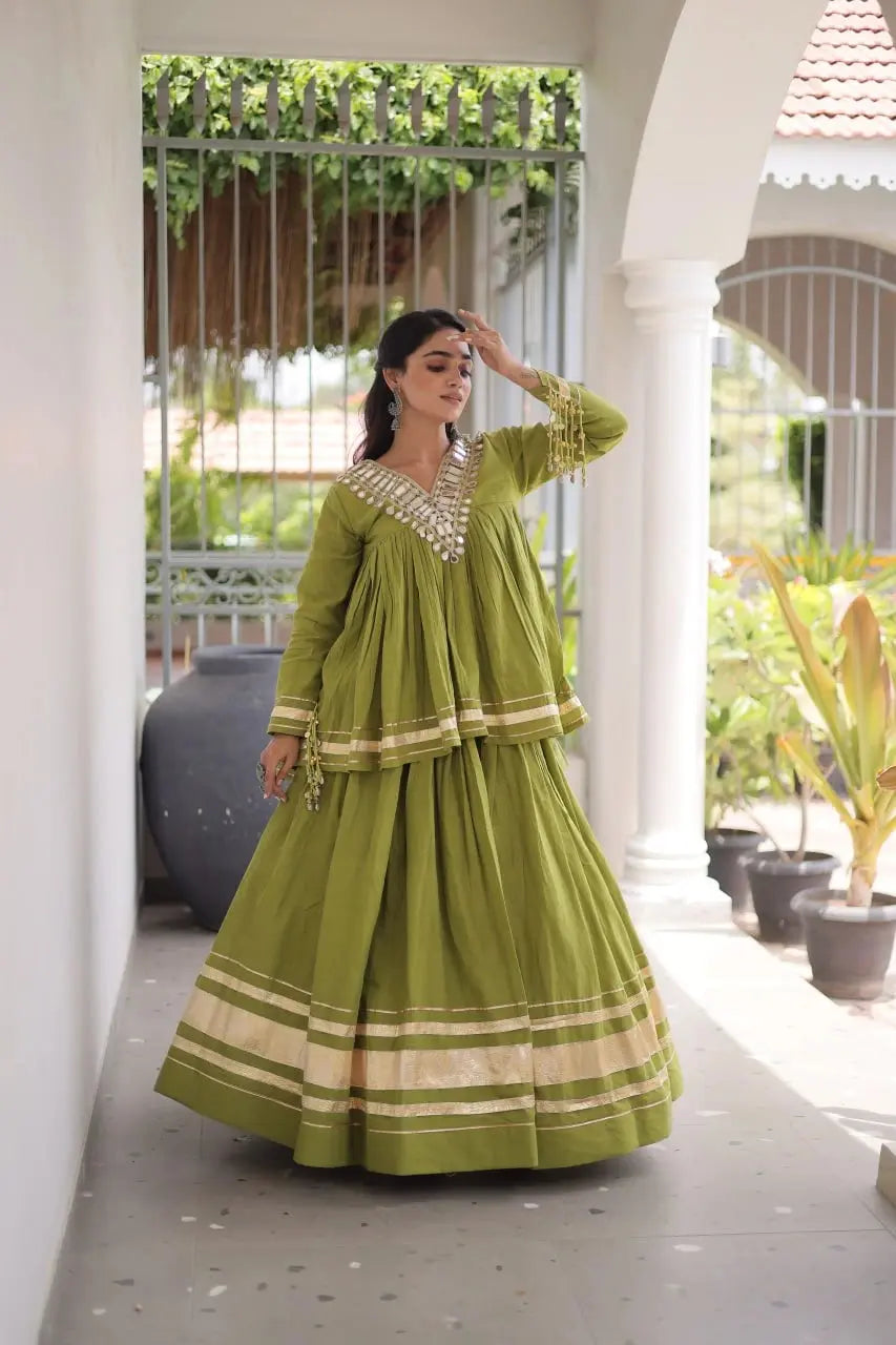 Green Zari Work Lehenga three quarter view – long peplum top with kodi coin tassels at cuffs, gota patti lace on hem
