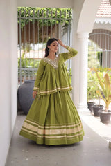 Green Zari Work Lehenga three quarter view – long peplum top with kodi coin tassels at cuffs, gota patti lace on hem