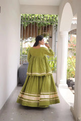 Green Zari Work Lehenga back view – covered back peplum top, circular skirt with multiple gold zari and gota patti lace borders