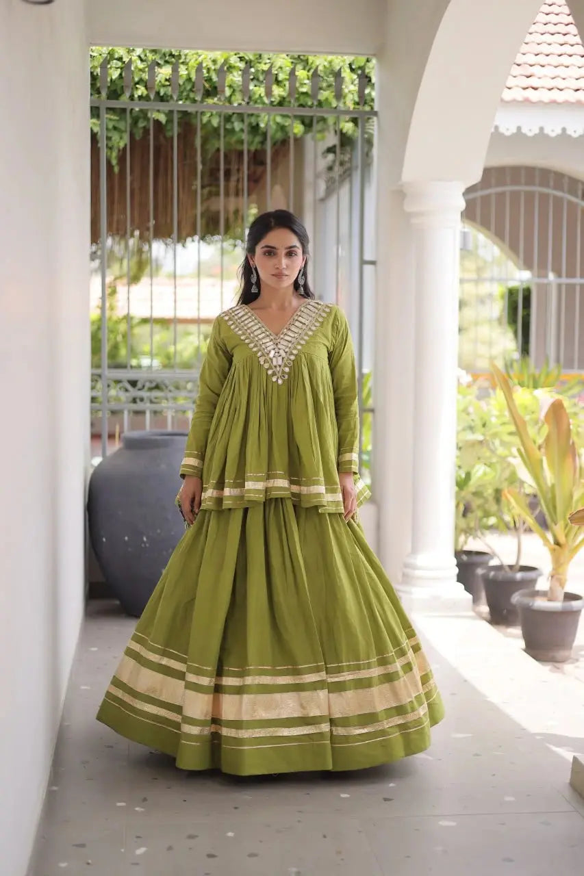 Green Kora Cotton Lehenga standing front – olive green peplum top with mirror work neckline, circular skirt with zari border
