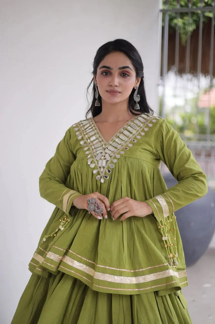 Green Zari Work Lehenga neckline close-up – shisha mirror V-neck embroidery, kodi bead tassels, zari cuff border detail