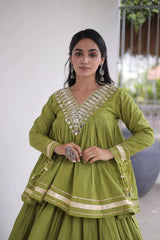 Green Zari Work Lehenga neckline close-up – shisha mirror V-neck embroidery, kodi bead tassels, zari cuff border detail