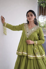 Green Lehenga top close-up – rectangular and teardrop shisha mirror work at V-neckline, kodi coin tassel cuffs, Navratri festive wear