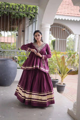 Purple Zari Work Lehenga – Model wearing purple peplum lehenga set with gold zari borders and kodi tassel cuffs