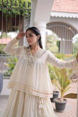 White Zari Work Lehenga – Model wearing white peplum lehenga set with gold zari borders and kodi tassel cuffs