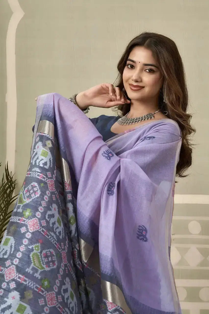 Half body view of Lavender Zari Woven Saree — holding pallu showing elephant and bird Patola motifs