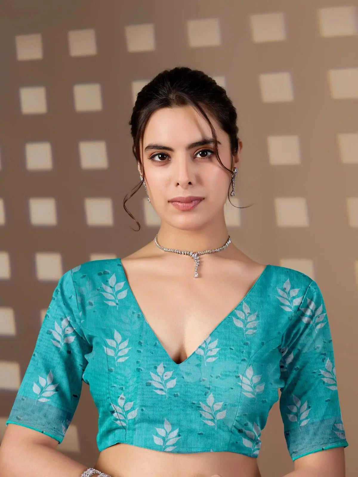 Close-up of matching teal running blouse piece — Aqua Blue Saree V-neck with white leaf print blouse