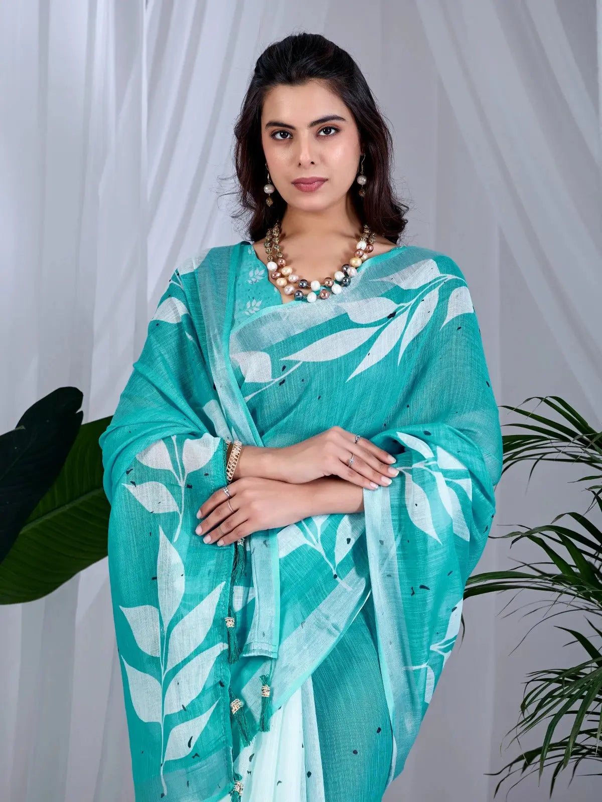 Close-up half body of Aqua Blue Saree — white leaf motif print detail on teal linen cotton fabric