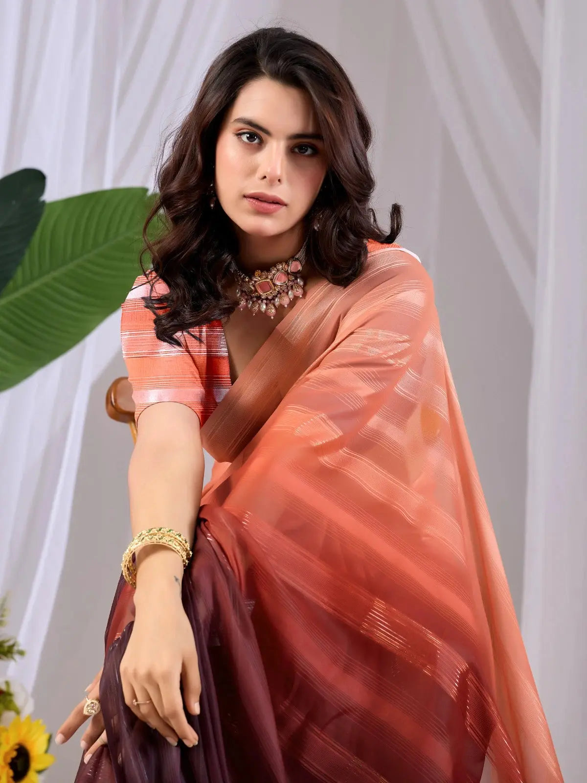 Half body close-up of Soft Peach Wine Ombre Saree — silver woven diagonal stripes on peach fabric