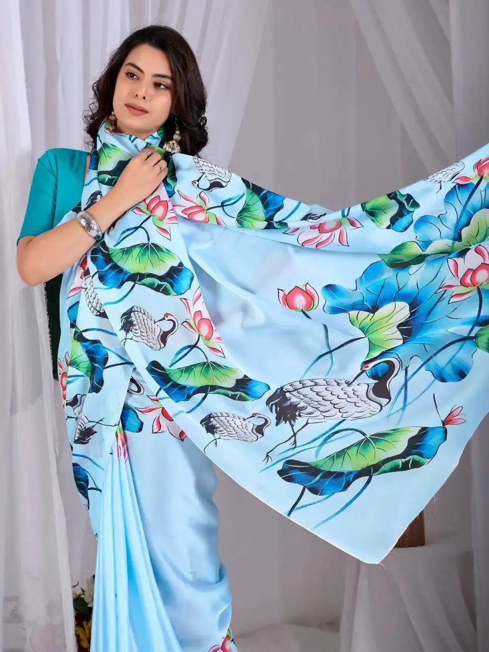 Sky Blue Satin Georgette Saree – pallu held wide showing full crane and lotus print expanse