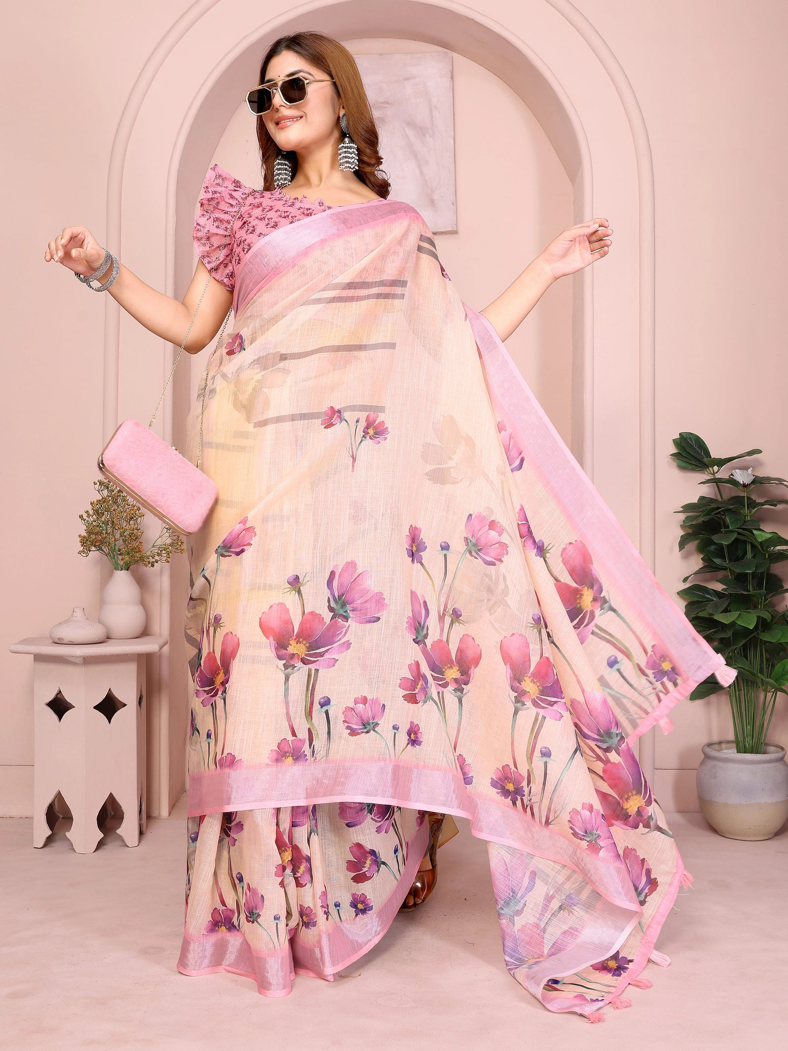 Peach Linen Cotton Saree – front drape styled with sunglasses and clutch, cosmos floral print and pink border