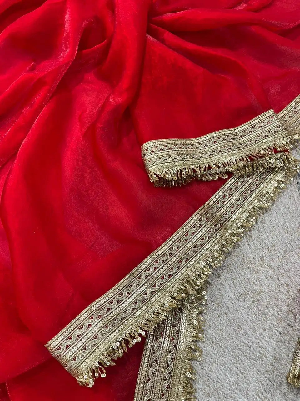 Red Satin Silk Saree border detail – multi-band gold lace with zari stripe, cutwork and sequin fringe trim
