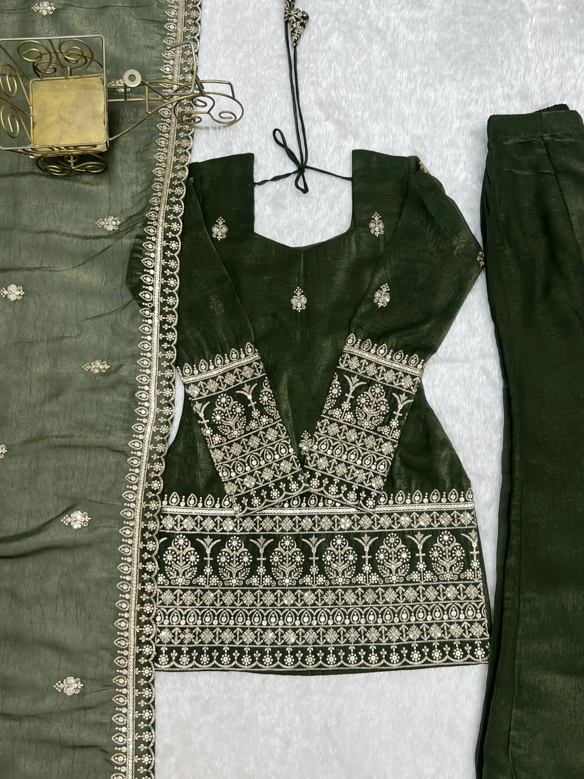 Flat lay close-up of heavy sequin and zari embroidery bands on Olive Green Suit hem