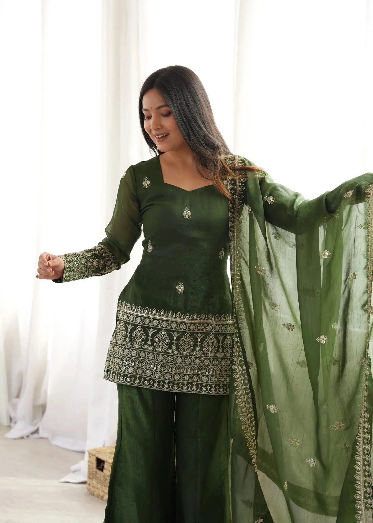 Model view highlighting dense sequin and zari embroidery at hem of Olive Green Suit