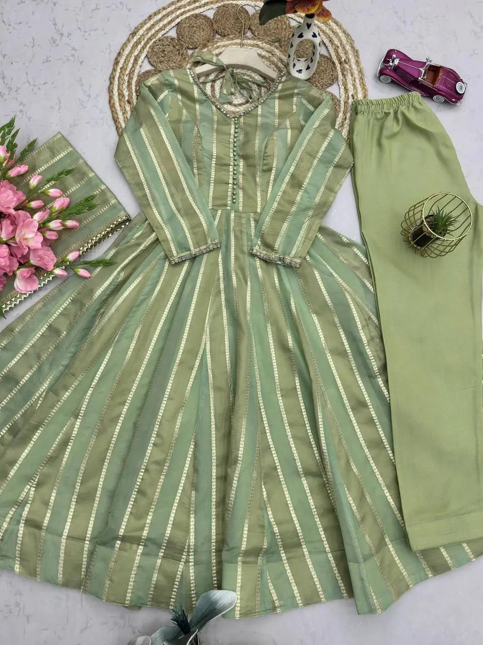 Soft pastel green mirror work suit set flat lay with dupatta and straight pants