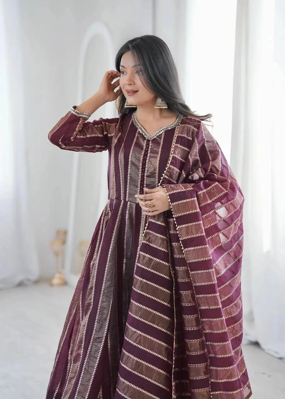 Close-up portrait of mirror work neckline and cuff on wine anarkali suit
