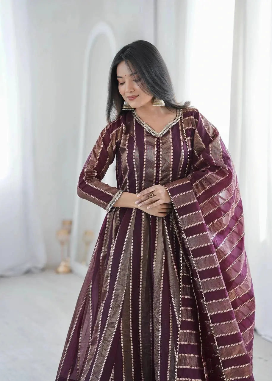 Close-up of mirror work V-neckline on wine bronze striped jacquard suit