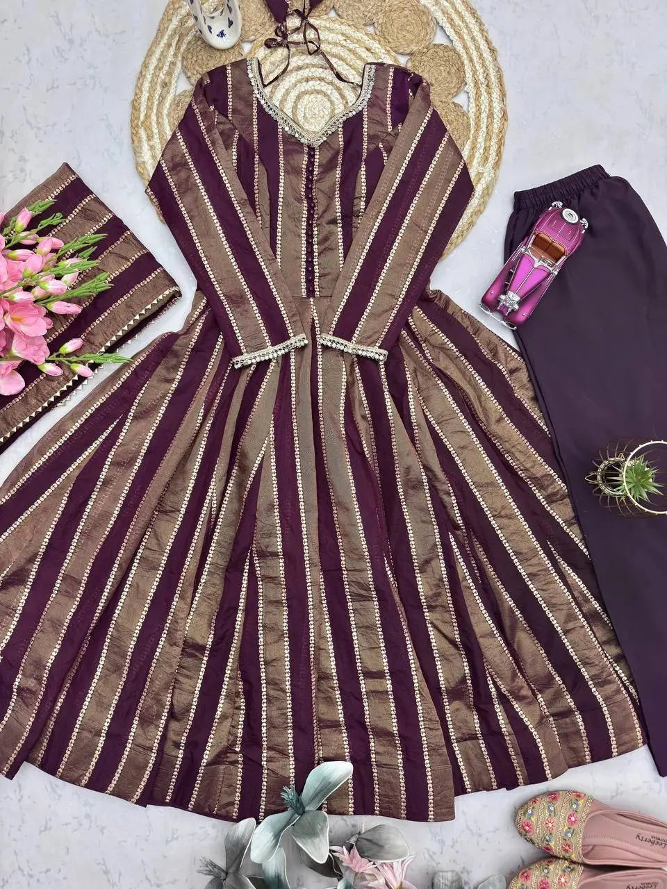 Close-up flat lay of bronze striped jacquard fabric and straight pants
