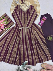 Close-up flat lay of bronze striped jacquard fabric and straight pants