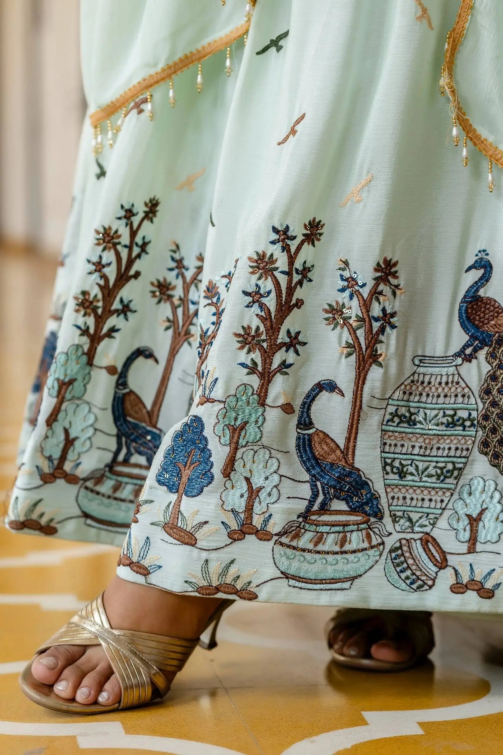 Close-up of peacock and tree embroidery on hem border – Pastel Green Anarkali Suit KU214