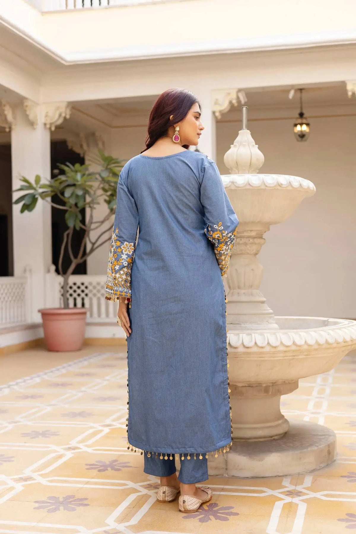 KU216 Grayish Blue Cotton Denim Suit back view – Covered back, showing embroidered sleeves with coin tassels and straight pants