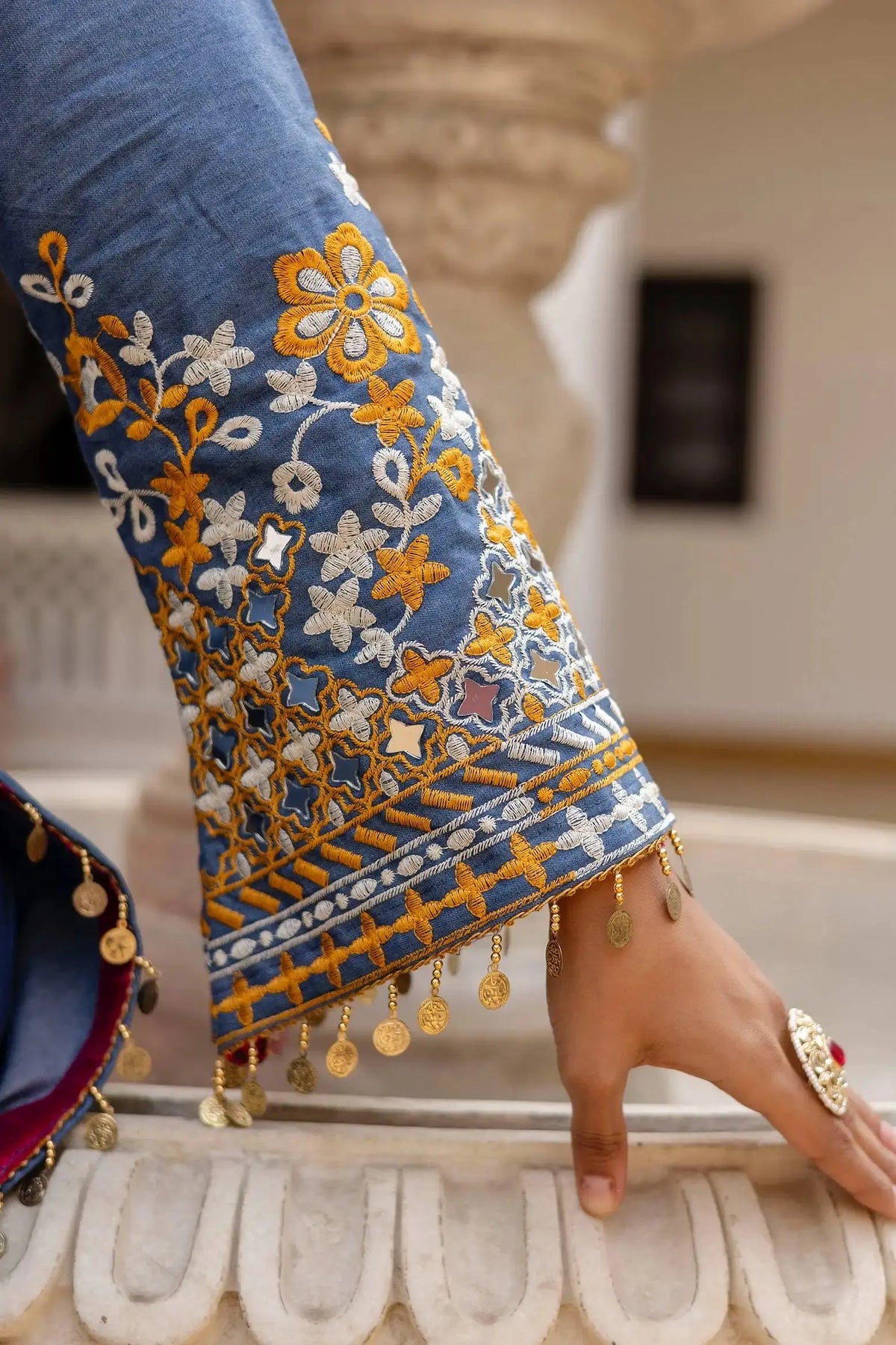 KU216 Heavy Embroidered Suit – Sleeve detail showing dense floral embroidery, mirror inserts and gold coin tassel border