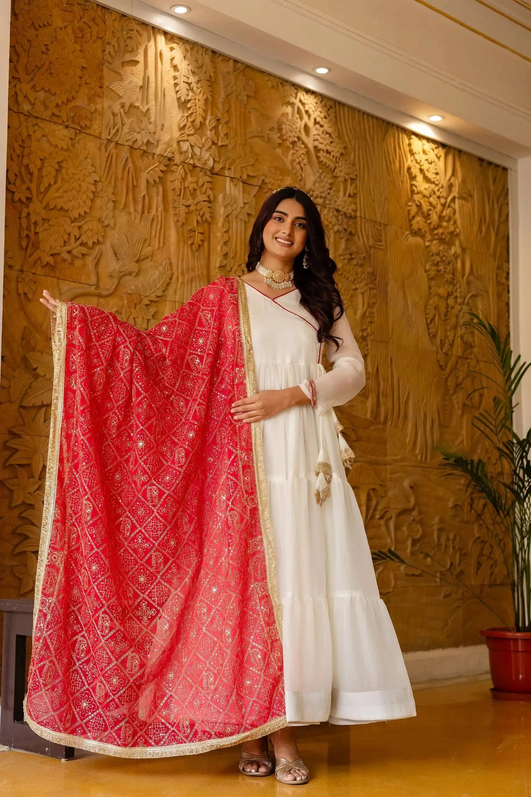 KU217 White NC Moss Anarkali Suit – Holding dark pink Bandhej dupatta wide, showing full 3-tier flair