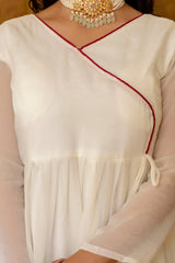 KU217 White Anarkali Suit – Close-up of V-neck with red contrast trim and gold tassel tie-up