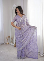 Woman wearing a lavender saree with silver details in a minimalistic setting