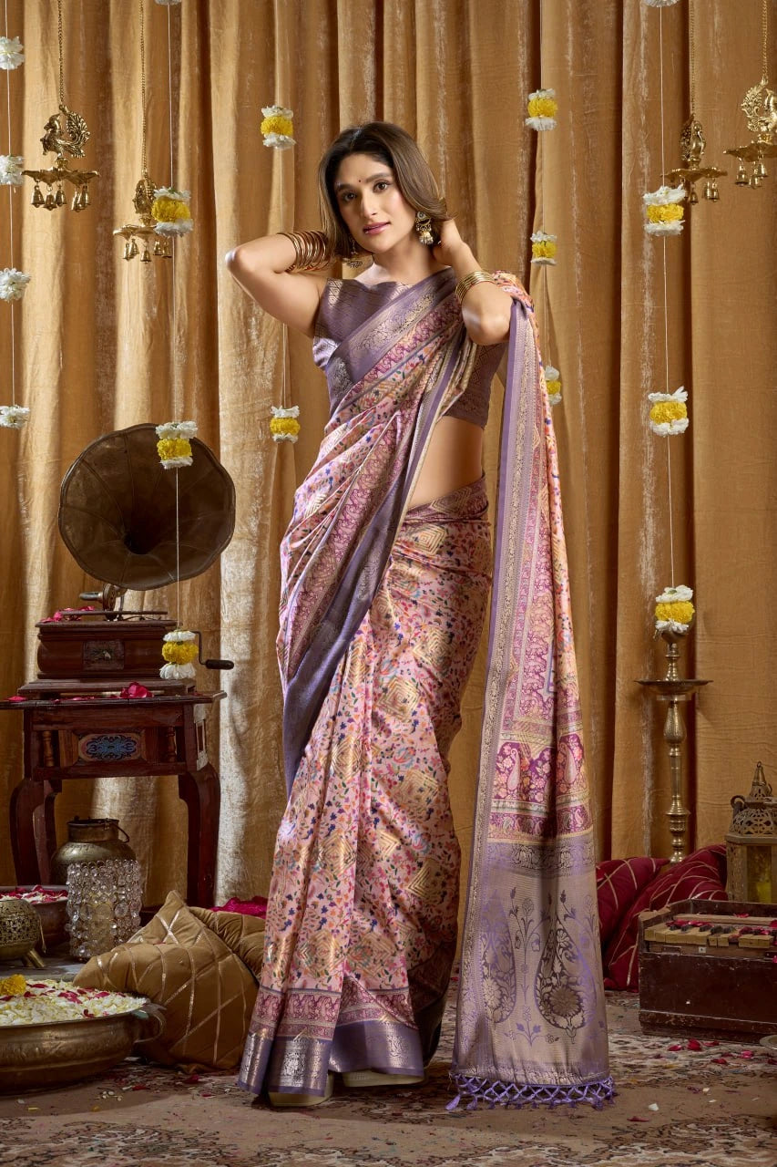 Woman in a traditional saree standing in a decorated room with ornate curtains and decor.