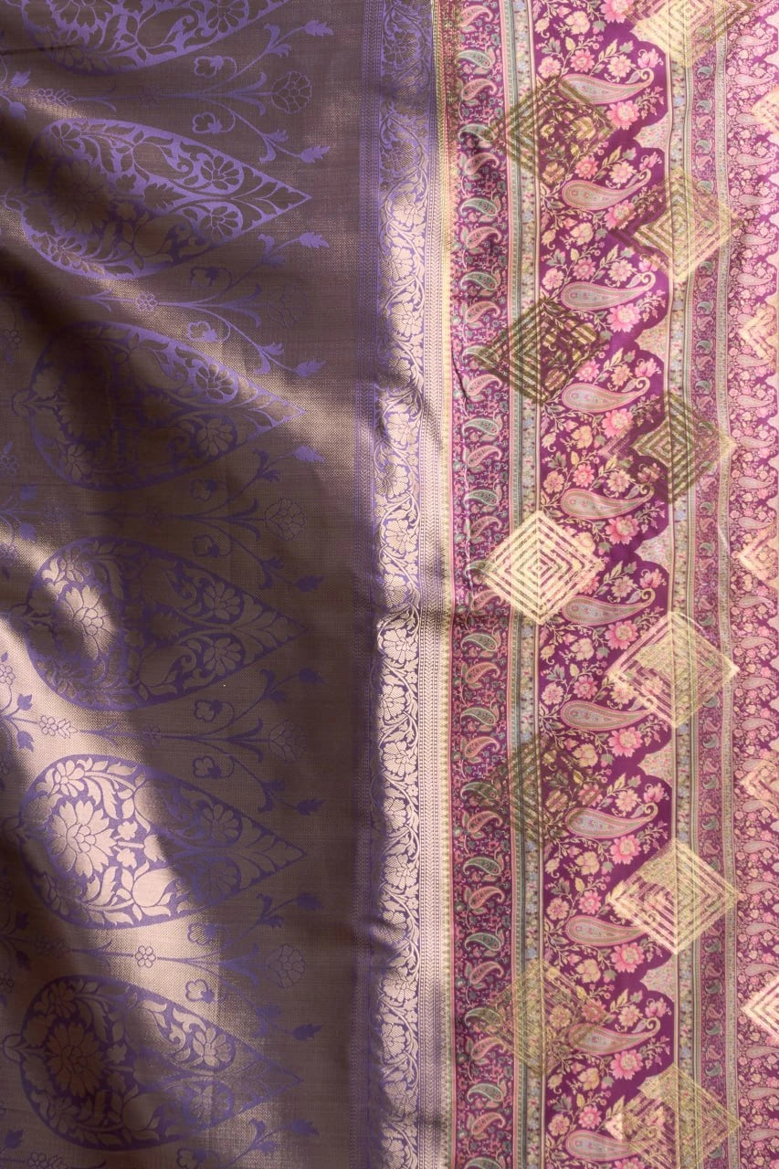 Close-up of patterned fabric with intricate designs on a purple and pink background