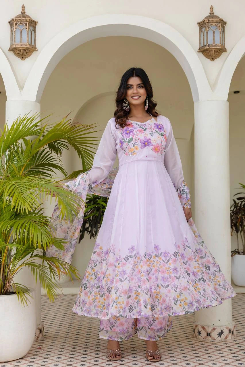 Women's pastel lavender Anarkali suit featuring floral embroidery, printed dupatta, and ethnic elegance.