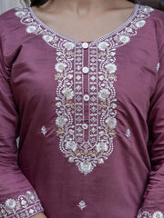 Maroon traditional outfit with intricate white embroidery on a plain background