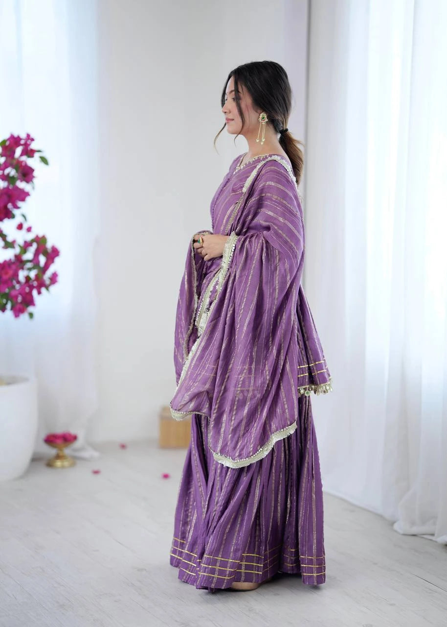 Woman wearing a purple traditional outfit with a white background